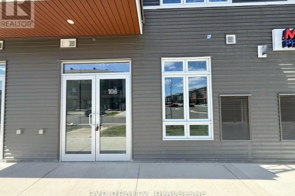 Ground floor entrance to unit 106, featuring double glass doors and large windows. - 106 - 3600 Brian Coburn Boulevard, Ottawa