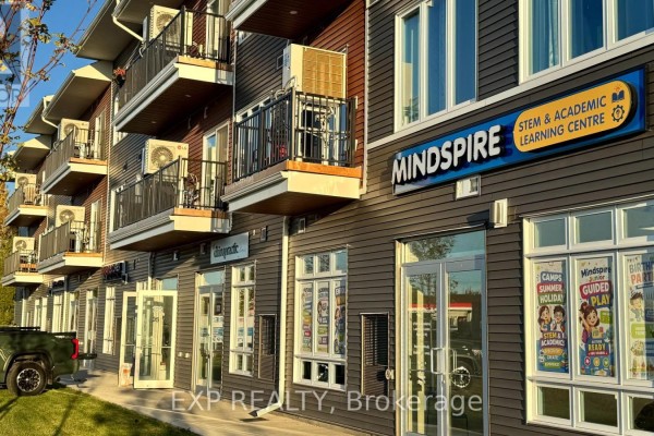 Facade view of Mindspire Learning Centre and other businesses with outdoor seating and windows. - 106 - 3600 Brian Coburn Boulevard, Ottawa