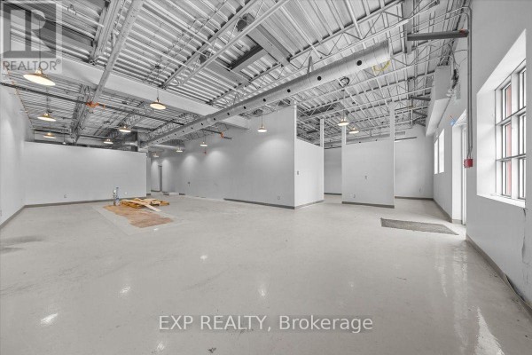 Empty commercial space with white walls, exposed metal ceiling, and industrial lighting. - 106 - 40 Sunset Boulevard, Perth