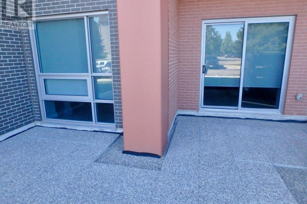 Exposed aggregate patio with large window and sliding door - 106 - 4040 Upper Middle Road, Burlington