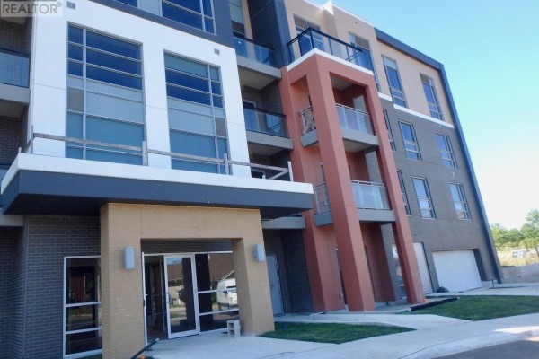 Modern building exterior with brick facade, balconies, large windows - 106 - 4040 Upper Middle Road, Burlington