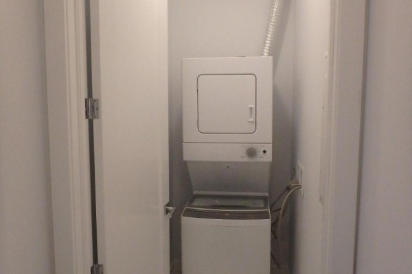 Stacked washer and dryer in laundry closet - 106 - 4040 Upper Middle Road, Burlington