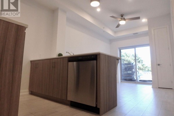 Modern kitchen with cabinets, dishwasher, tile floor, ceiling fan, sliding door - 106 - 4040 Upper Middle Road, Burlington