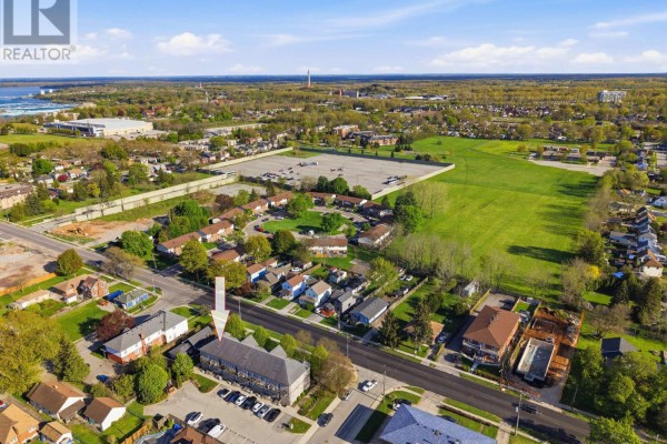 Aerial view of a townhouse complex surrounded by residential areas and green spaces. - 106 - 6045 Dunn Street, Niagara Falls