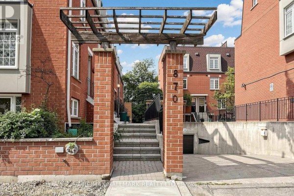 Pathway leading to townhouse entrance with brick pillars, steps, and address number 870. - 106 - 870 Jane Street, Toronto