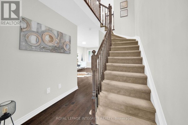 Living area featuring hardwood floors, desk, and large windows - 106 Wild Senna Way, Ottawa
