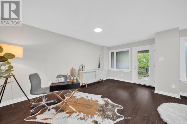 Bright room with hardwood floors, desk, and access to outdoor space - 106 Wild Senna Way, Ottawa