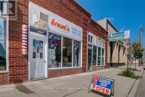 Barber shop exterior with open sign and large windows displaying services. - 1062 - 1066 Dundas Street E, London East