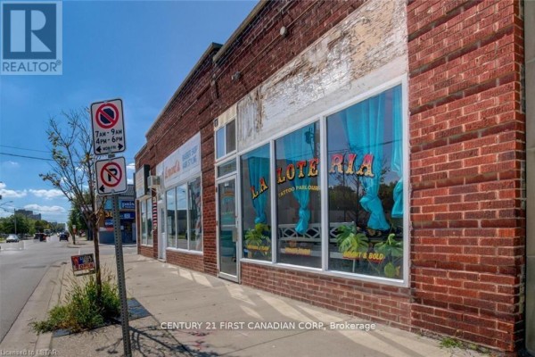 Facade of the building showing a lottery shop with large windows and colorful decor. - 1062 - 1066 Dundas Street E, London East