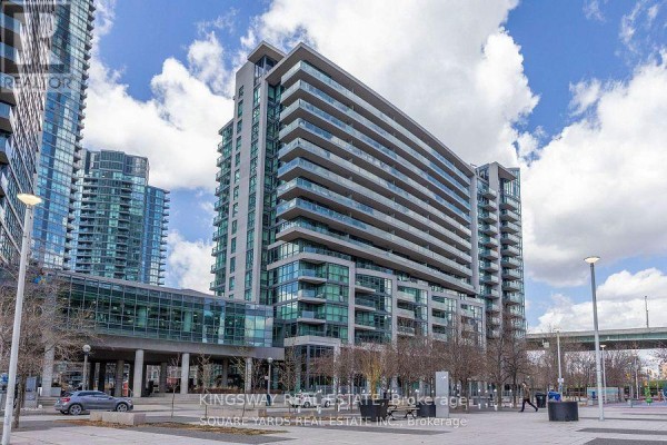 Angled exterior shot of a condo building with a glass skywalk and surrounding plaza. - 1062 - 209 Fort York Boulevard, Toronto