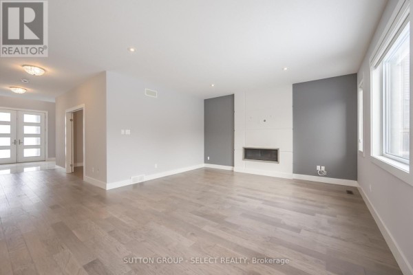 Wooden staircase with glass railings and marble tile flooring in an entryway. - 1062 Melsetter Way, London North