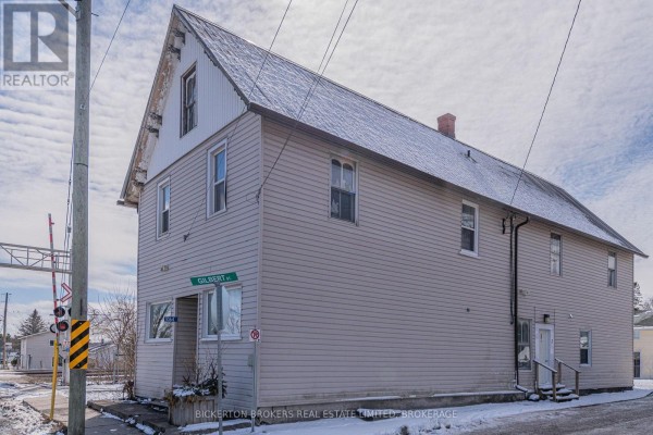 Corner view of a light beige two-story home showing Prince Street and Gilbert Street signage. - 1064 Prince Street, Lansdowne Village