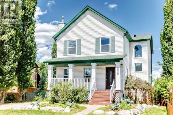 Kitchen with light wood cabinets, stainless steel appliances, and an island. - 107 2a Avenue Nw, Diamond Valley