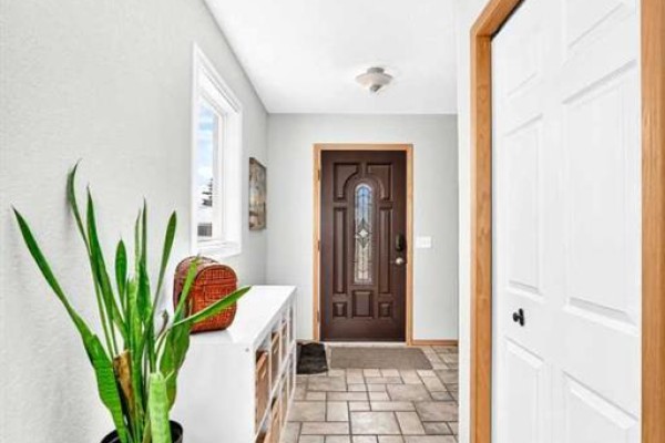 Kitchen with light wood cabinets, stainless steel appliances, and an island. - 107 2a Avenue Nw, Diamond Valley