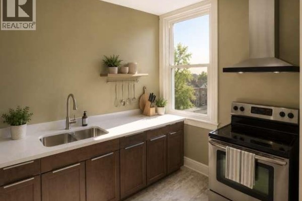 Kitchen with stainless steel refrigerator, wooden cabinets, white countertop, and sink. - 107 Brant Avenue Unit# Upper, Brantford