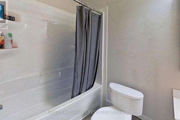 Bathroom with bathtub, shower curtain, and toilet - 107 Cavendish Crescent London North