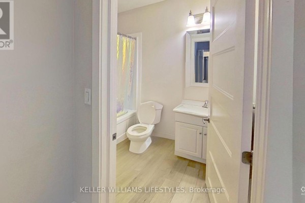 Bathroom with toilet, sink, tub, and vanity - 107 Cavendish Crescent London North