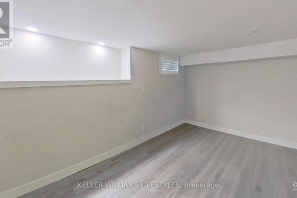 Modern finished basement with laminate flooring and recessed lighting - 107 Cavendish Crescent London North