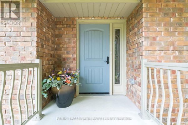 Front entrance porch with a light blue door, sidelight window, and railings. - 107 George Street, Clearview