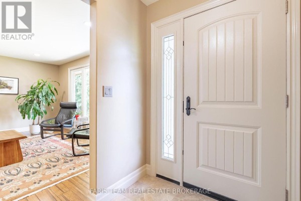Interior entryway with a white double door, glass panel, and beige walls. - 107 George Street, Clearview