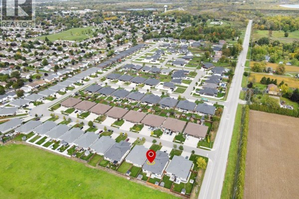 Aerial view of a suburban neighborhood with rows of houses and surrounding farmland. - 107 Meadowview, Amherstburg