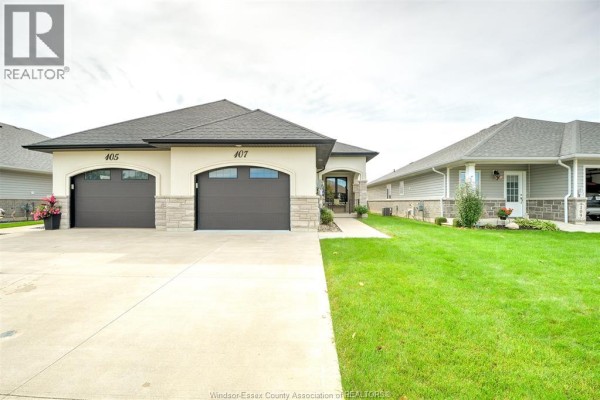 Front view of a detached house featuring a double garage and light-colored stone accents. - 107 Meadowview, Amherstburg