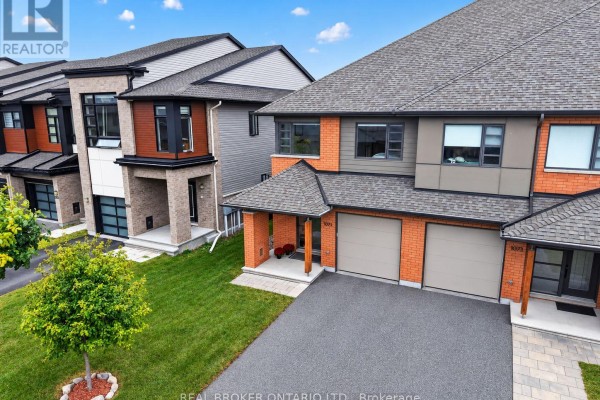 Aerial view of townhouses on Lunar Glow Crescent with green lawns and trees. - 1071 Lunar Glow Crescent, Ottawa