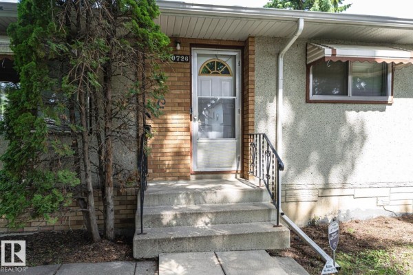Close-up of the front entrance steps, door, and adjacent brickwork. - 10726 70 Av Nw, Edmonton