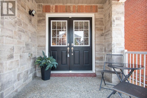 Close-up of a double front door with decorative glass panels. - 1079 Job Crescent, Milton