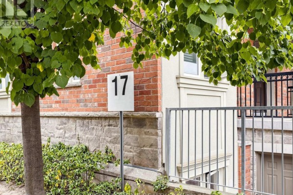 Close-up of townhouse entrance with address number 17 on a white sign. - 108 - 17 Coneflower Crescent, Toronto