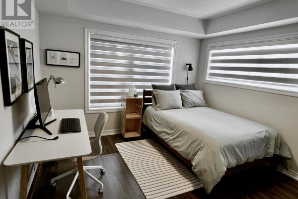 Bedroom with single bed, desk, and dual windows with blinds - 108 - 2 Cove Court, Collingwood