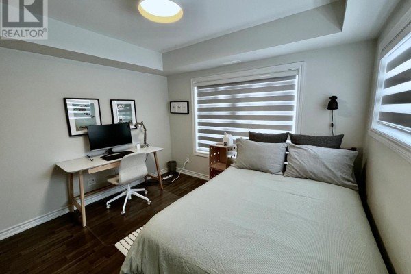 Another view of the bedroom showing desk setup and bedding details - 108 - 2 Cove Court, Collingwood