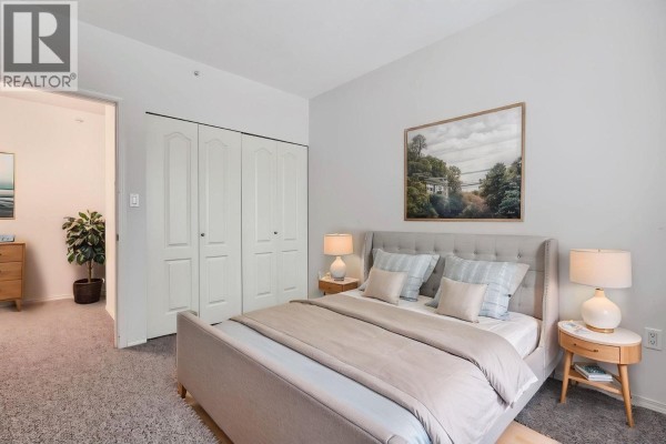 Bathroom with tiled shower, toilet, sink, and vanity with mirror. - 108 12148 224 Street, Maple Ridge