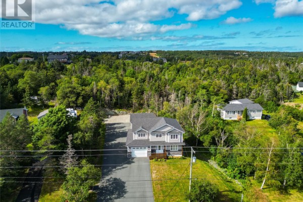 Aerial view of a grey two-story house surrounded by trees and residential properties. - 108 Country Drive, Torbay
