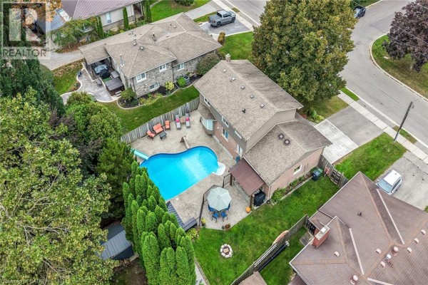 Aerial view of a residential house with a pool and backyard amenities. - 108 Temperance Street E, Waterford