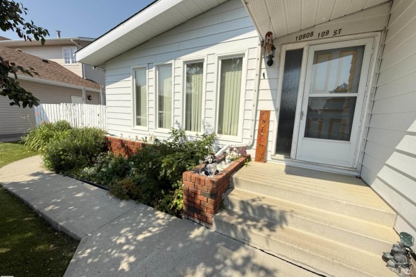 Close-up of the front entrance with white door and glass panel. - 10808 109 Street, Westlock