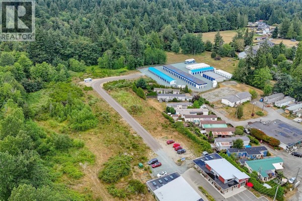 Aerial view of undeveloped land with treed hills and coastal views. - 10862 Chemainus Rd, Chemainus