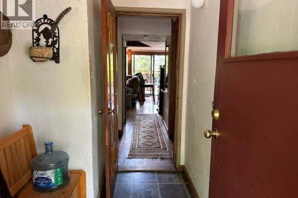 View from the front door looking down a hallway into a living area. - 1087 Chappel Pl, Gabriola Island