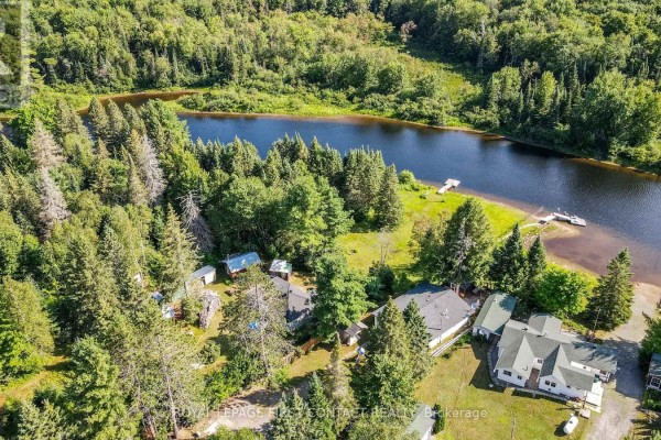 Scenery of the property entrance with a generator and a gravel clearing. - 1088 Colony Road, Lake Of Bays