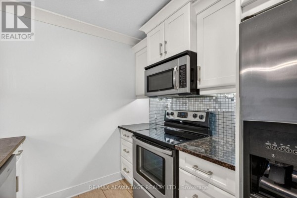 Second bedroom with queen bed, nightstands, dresser, and windows with curtains. - 109 - 320 Sugarcreek Trail, London North