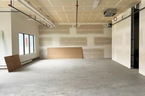 Unfinished interior space with exposed ductwork, concrete floor, and drywall. - 109 1132 College Drive, Saskatoon