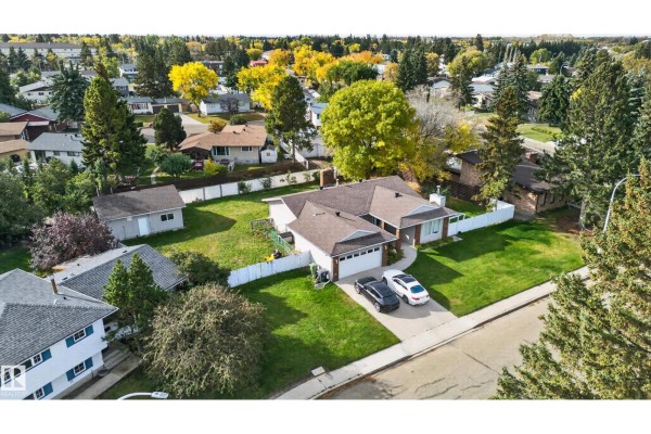 Aerial view of a residential street showing a bungalow with a large yard and surrounding houses. - 109 Evergreen Cr, Wetaskiwin