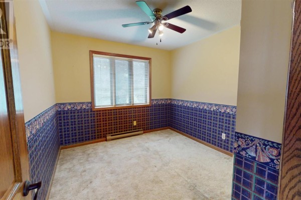 Bedroom with ceiling fan and blue patterned wallpaper - 109 Greenview Ln Sault Ste Marie