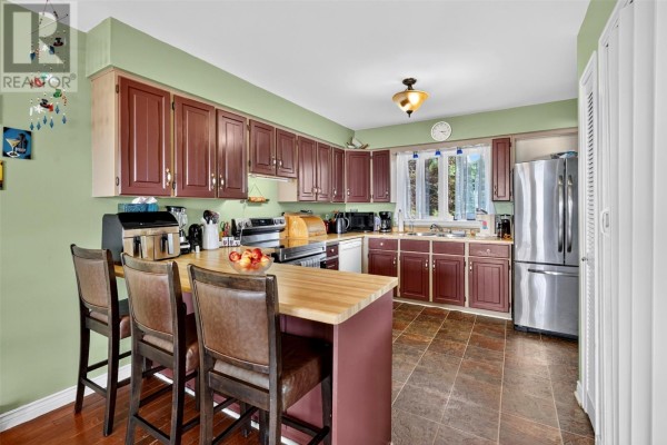 Deck with double glass doors and windows overlooking the water and surrounding greenery. - 109 Trinity South Highway, Cavendish