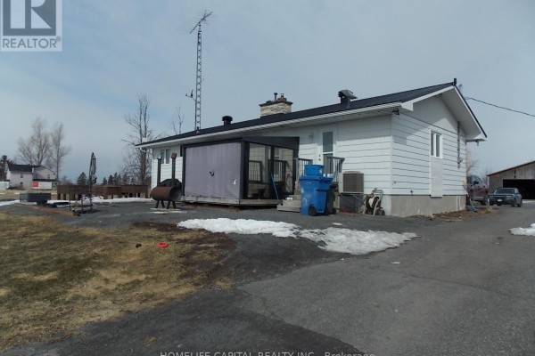 White outbuilding with multiple garage door openings and weathervane - 1091 County Rd 15 Road, Alfred And Plantagenet