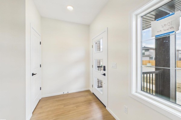 Living room view with large windows and hardwood flooring - 1096 Mcleod Av, Spruce Grove