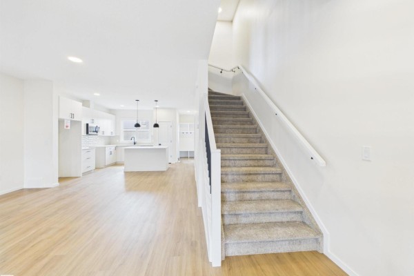 Bright living area with electric fireplace and multiple windows - 1096 Mcleod Av, Spruce Grove
