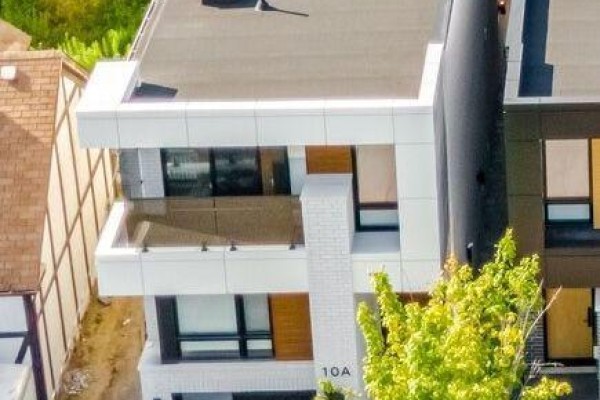 Close-up view of the modern exterior of 10a Holmstead Avenue with white and wood accents. - 10a Holmstead Avenue, Toronto