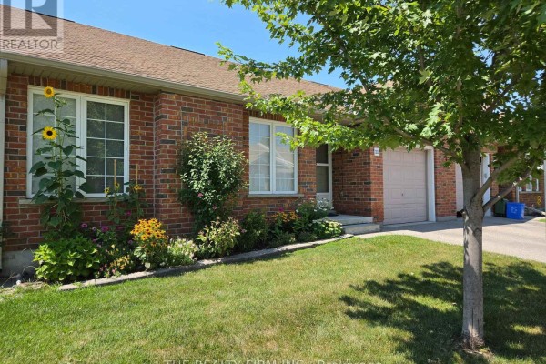 Front view of a brick townhouse with a garage and front door. - 11 - 100 Stroud Crescent, London South