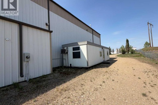 Exterior of white modular office connected to large industrial building. - 11 & 13, 27123 Highway 597, Rural Lacombe County